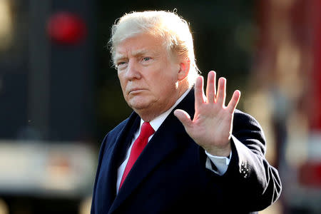 FILE PHOTO: U.S. President Donald Trump waves prior to departing on a trip to Wisconsin from the White House in Washington, U.S., October 24, 2018. REUTERS/Cathal McNaughton/File Photo