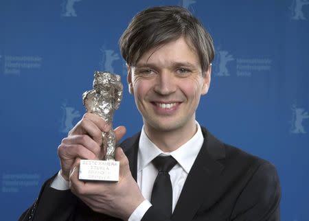 Cinematographer Sturla Brandth Grovlen poses backstage with his Silver Bear for an Outstanding Artistic Contribution in the categories camera, editing, music score, costumes or set design for his film 'Victoria', at the awards ceremony of the 65th Berlinale International Film Festival in Berlin February 14, 2015. REUTERS/Tim Brakemeier/Pool