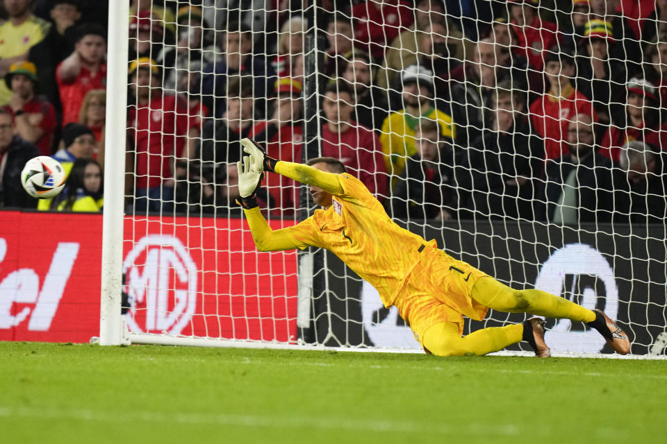 Poland's goalkeeper Wojciech Szczesny saves a penalty from Wales Daniel James during Euro 2024 soccer play-off match between Wales and Poland at Cardiff City Stadium, Wales, Tuesday, March 26, 2024. (AP Photo/Alastair Grant)