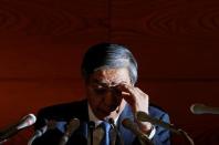 Bank of Japan (BOJ) Governor Haruhiko Kuroda touches his glasses during a news conference at the BOJ headquarters in Tokyo November 19, 2014. REUTERS/Yuya Shino/File Photo