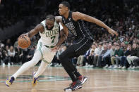 Boston Celtics guard Jaylen Brown (7) drives to the basket against Brooklyn Nets center Nic Claxton (33) during the first half of an NBA basketball game, Wednesday, Feb. 1, 2023, in Boston. (AP Photo/Charles Krupa)