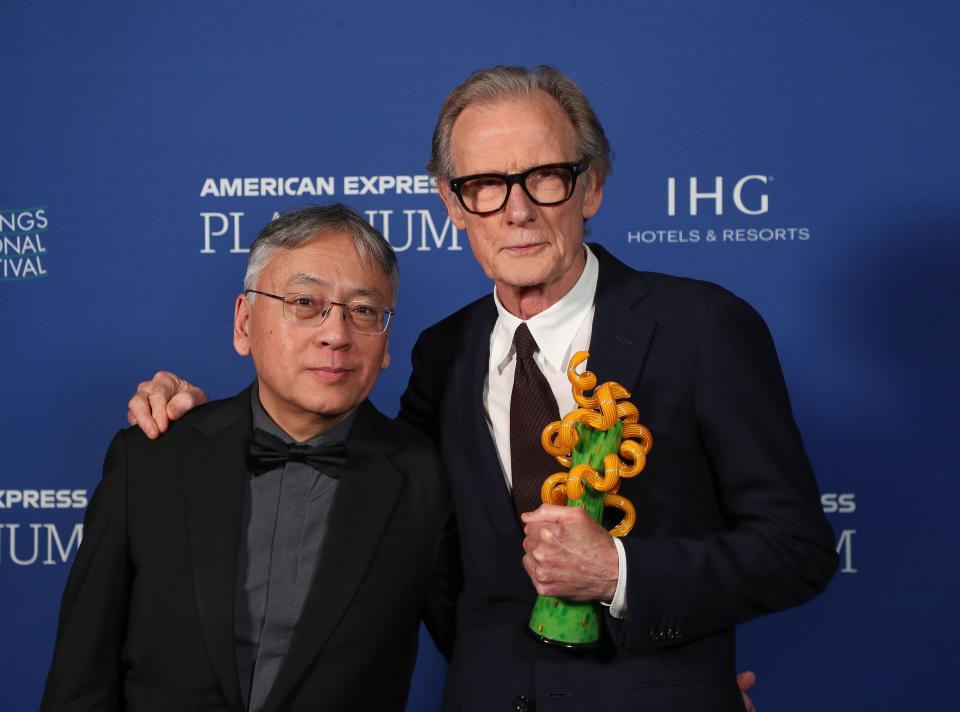 Kazuo Ishiguro and Bill Nighy pose with his International Star Award at the Palm Springs International Film Festival awards gala on Jan. 5 in Palm Springs, Calif.