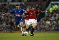 Roy Keane of Manchester United is tackled by Stan Lazaridis of Birmingham City as he attempts to strike the ball