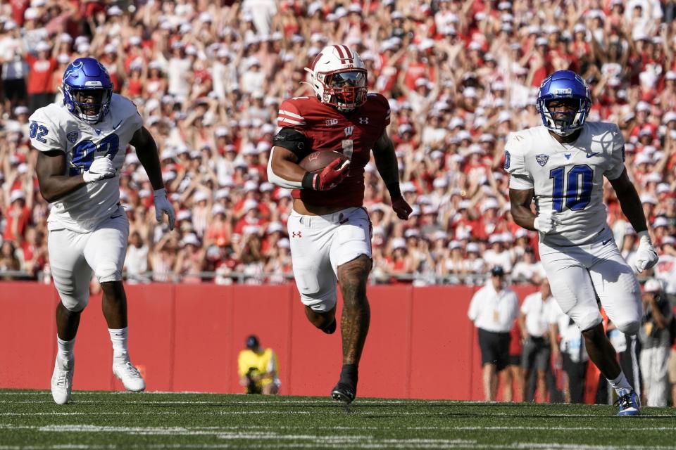 Wisconsin's Chez Mellusi (1) runs for a touchdown during the second half of an NCAA college football game against Buffalo Saturday, Sept. 2, 2023, in Madison, Wis. (AP Photo/Morry Gash)