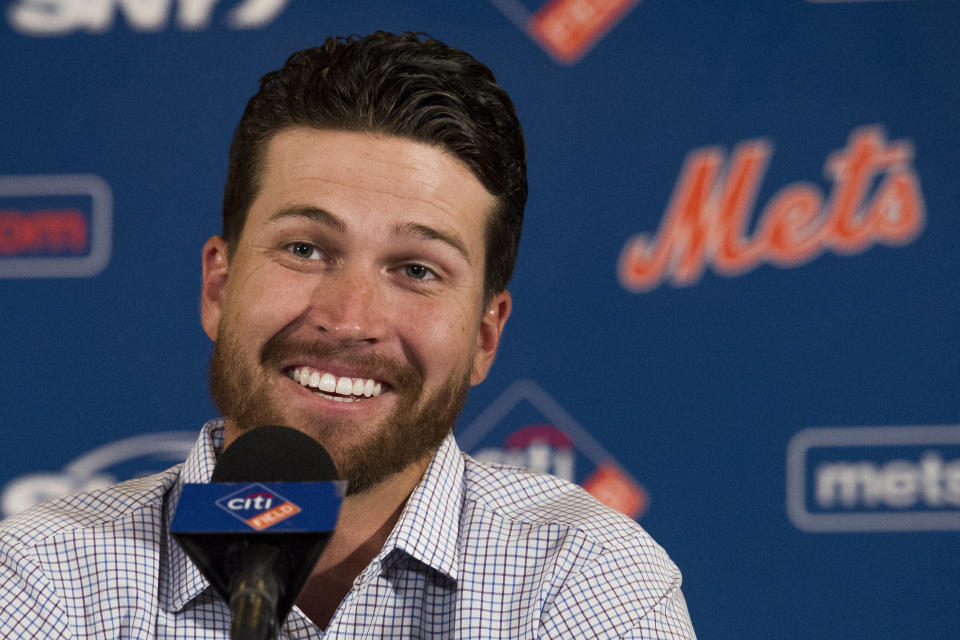 New York Mets pitcher Jacob deGrom smiles during a news conference Wednesday, March 27, 2019, in Arlington, Va.  The Cy Young Award winner and the Mets agreed to a $137.5 million, five-year contract, on Monday, March 25, a deal that includes $52.5 million deferred into the 2030s. (AP Photo/Cliff Owen)