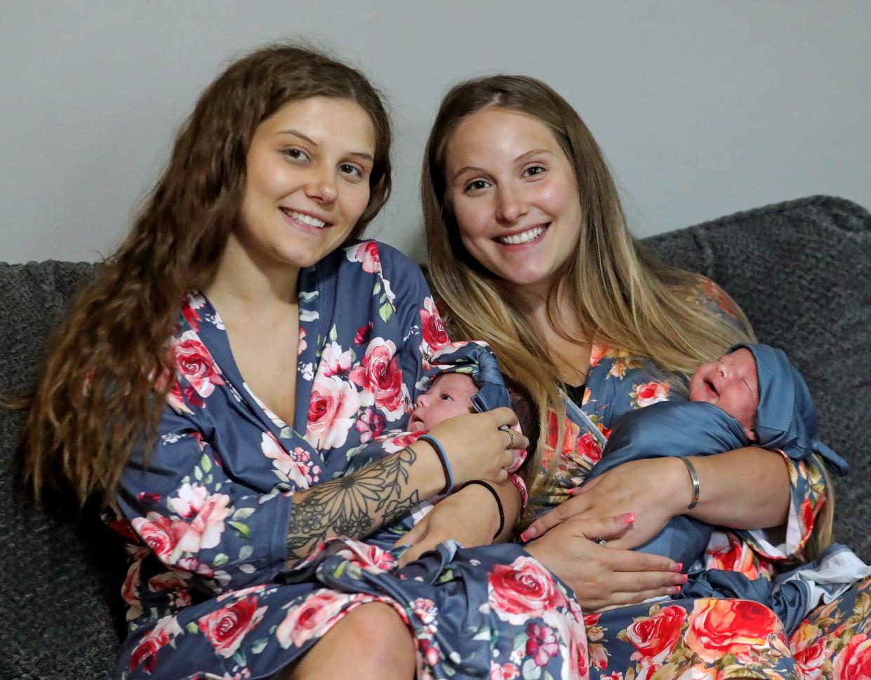 Sisters Adrianna Kennard, left, and McKayla Kennard pose with their babies Rylan and Kash June 26 in Akron. Rylan and Kash share the same June 18 birthday, as they were born 8 hours apart in the same birthing pool.