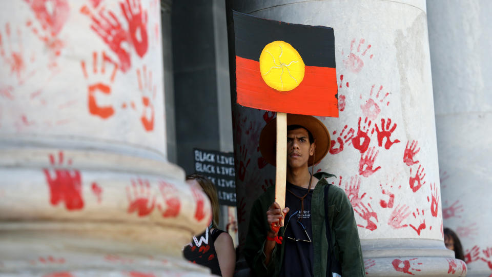 Protestors leave red paint hand prints on a pillar during a protest outside the South Australian Parliament in Adelaide, Wednesday, November 13, 2019. Aboriginal and Torres Strait Islander communities and allies are calling for justice for 19-year-old Warlpiri teenager Kumanjayi Walker, who died after being shot by police on Saturday night in the central desert town of Yuendumu in the Northern Territory. (AAP Image/Kelly Barnes) NO ARCHIVING