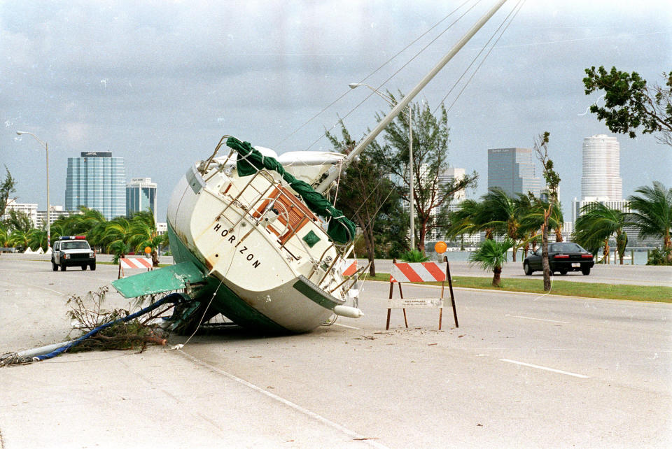 <p>A sailboat rests on the Rickenbacker Causeway to Key Biscayne with the Miami downtown skyline in the background August 26, 1992 two days after Hurricane Andrew ripped through south Florida. (Rick Wilking /Landov/Reuters) </p>