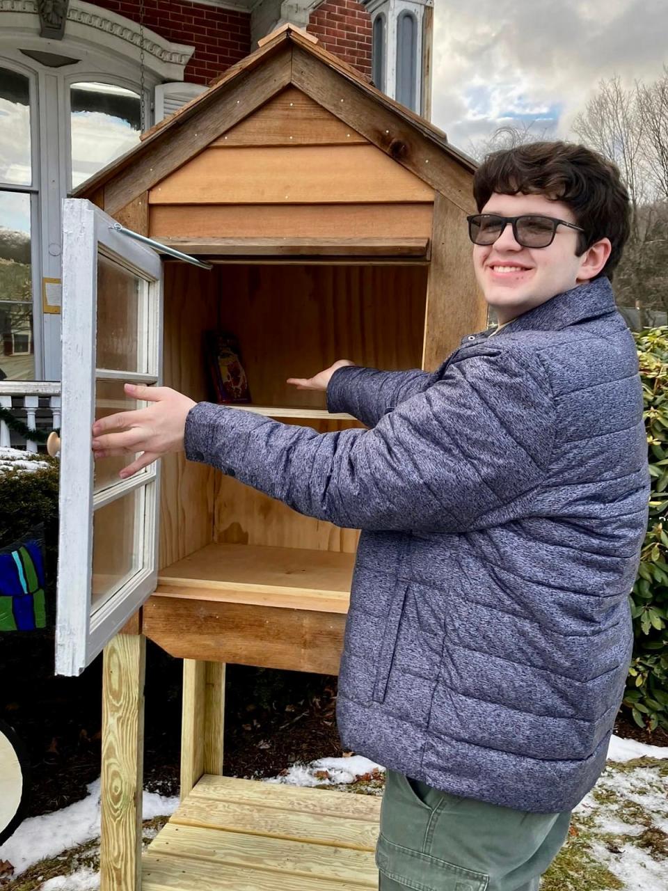 Honesdale's Brodie Cole unveils his finished Eagle Scout project: A "Little Free Library" constructed on the grounds of the Wayne County Public Library on North Main Street.