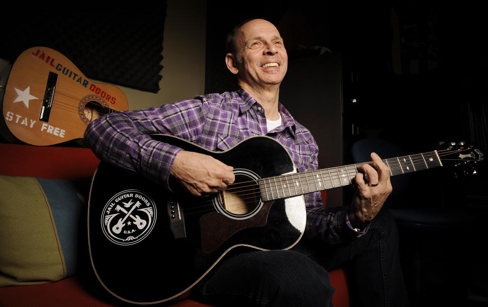 FILE - Guitarist Wayne Kramer, founder of the band the MC5, plays one of the instruments that will be provided to jail inmates as part of the Jail Guitar Doors USA initiative, Monday, Jan. 16, 2012, at Kramer's recording studio in Los Angeles. Kramer, died Feb. 2, 2024, at age 75 of pancreatic cancer. The tributes that poured in following Kramer's death came from musicians praising the MC5 guitarist's contributions to rock music, as well as from prison reform advocates who extolled his legacy of bringing music to incarcerated people. (AP Photo/Chris Pizzello, File)