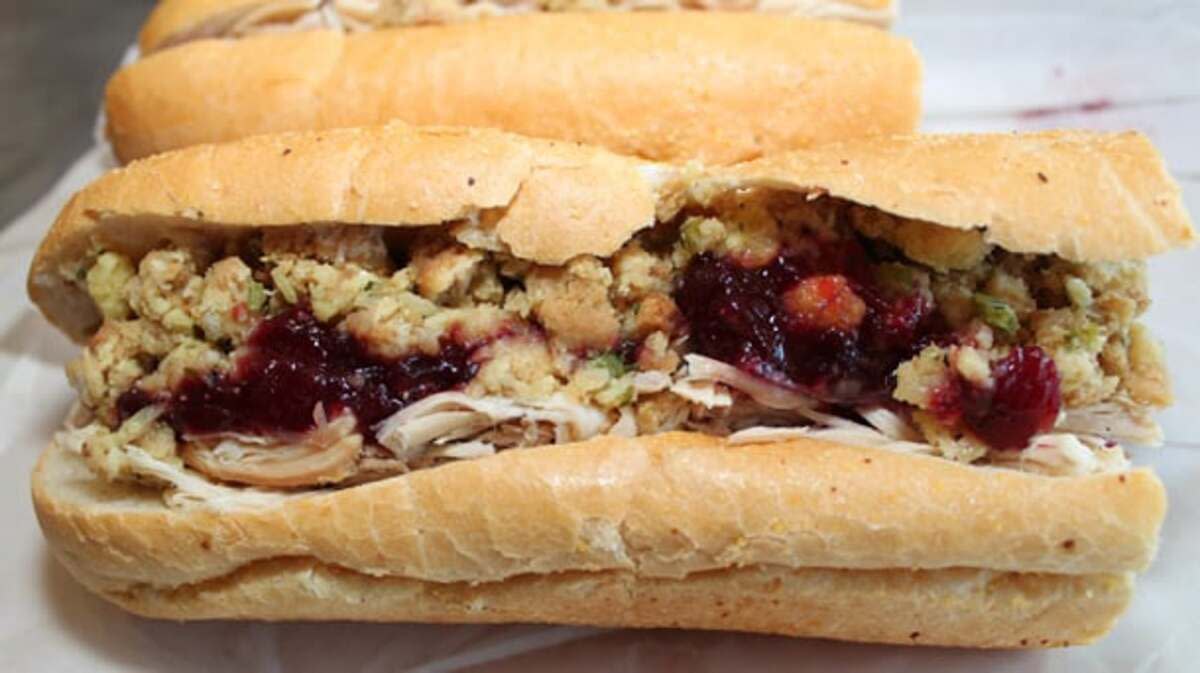 The Bobbie Sandwich on white serving paper, Capriotti's, Wilmington, Delaware, another sandwich behind it, on a grey table