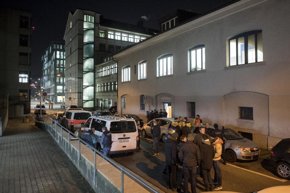 Police cars are parked in front of the Islamic center, in Zurich, Monday, Dec. 19, 2016. A Zurich police official says a gunman has injured several people in Switzerland's largest city. The official said police were swarming to the scene in pursuit of the gunman who remains at large. (Ennio Leanza/Keystone via AP)