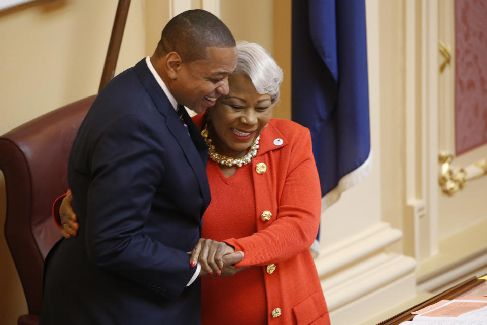 Senate President Pro Tempore, Sen. Louise Lucas, D-Portsmouth, right, gets a hug form Lt. gov. Justin Fairfax, after the vote to pass the ERA Resolution as she presides over the Senate at the Capitol, Monday Jan 27, 2020, in Richmond, Va. The resolution passed 27-12. (AP Photo/Steve Helber)