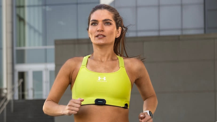  Garmin HRM-Fit chest strap heart rate monitor worn by female runner. 