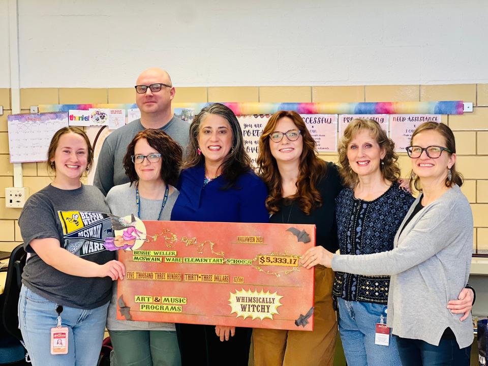 Staunton elementary art and music teachers are presented a check from Camille Dierksheide's Whimsically Witchy. Front, from left: Kat McLean (Ware), Kristin Bumbaugh (Bessie Weller), Camille Dierksheide, Kristen O'Neil (Ware), Gina Gaines (Ware) and Tina Purdy (McSwain). Back row: Berkeley Harner (McSwain).