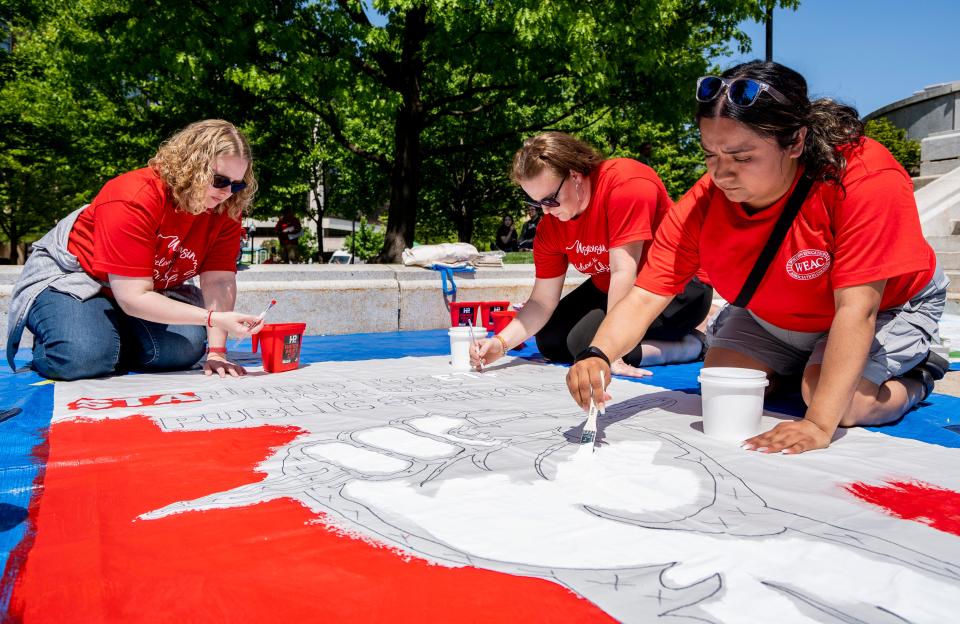 (Left to right) Barb Borre, a teacher at Nicolet Elementary School in Green Bay, Jessica Bernard, a teacher at Nicolet Elementary School in Green Bay, and Alondra Garcia, 2nd grade bilingual teacher at Milwaukee Public Schools, paint a banner at Wisconsin Education Association Council's rally to support Governor Evers’ education budget on Saturday May 20, 2023 at the Wisconsin State Capitol in Madison, Wis.