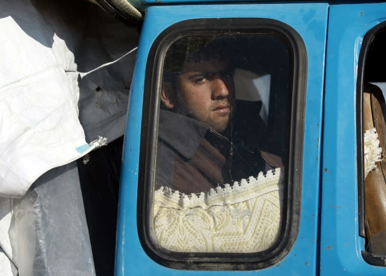 A displaced Syrian man waits inside a truck carrying his family's belongings at a checkpoint near the town of Manbij, northern Syria on March 6, 2017