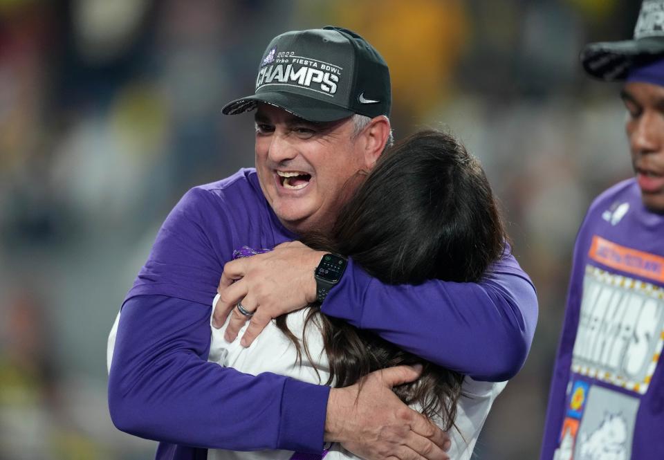 TCU head football coach Sonny Dykes hugs his wife, Kate, after defeating Michigan in the 2022 Fiesta Bowl in a College Football Playoff semifinal on Dec. 31