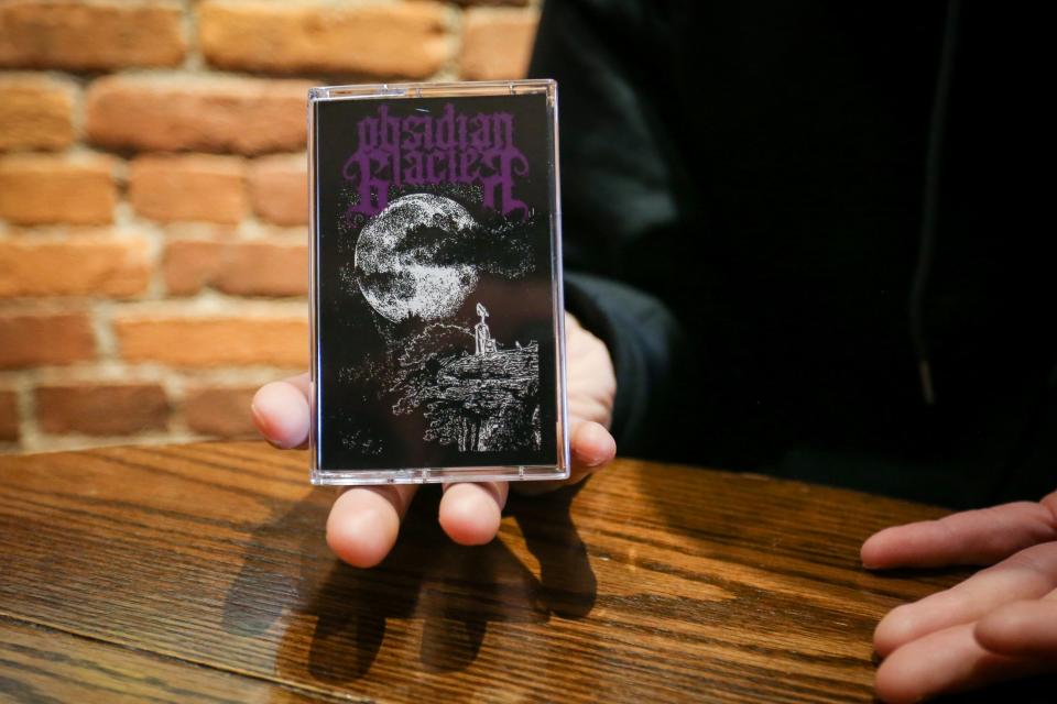 Obsidian Glacier Distro manager Kasey Denton holds an Obsidian Glacier cassette tape released on Thursday, March 30, 2023. Obsidian Glacier Distro is one of five independent record labels in Springfield.