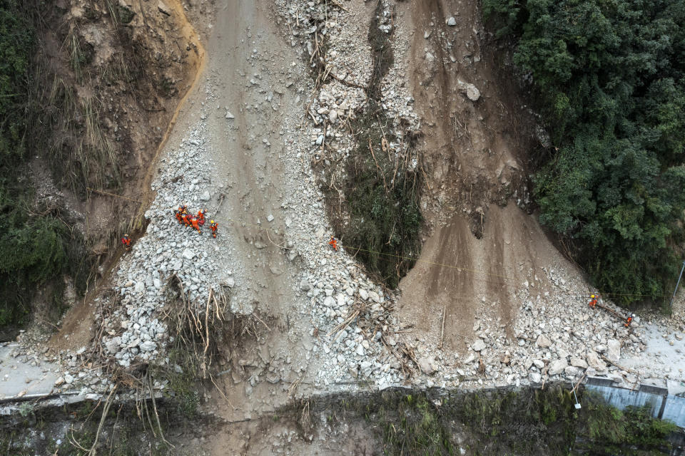 In this photo released by Xinhua News Agency, rescuers transfer an earthquake affected villager through a damaged mountain road near Moxi Town of Luding County, southwest China's Sichuan Province Wednesday, Sept. 7, 2022. The death toll in this week's earthquake in western China has jumped to more than dozen with plenty still missing, the government reported Wednesday, as frustration rose with uncompromising COVID-19 lockdown measures that prevented residents from leaving their buildings after the shaking. (Shen Bohan/Xinhua via AP)