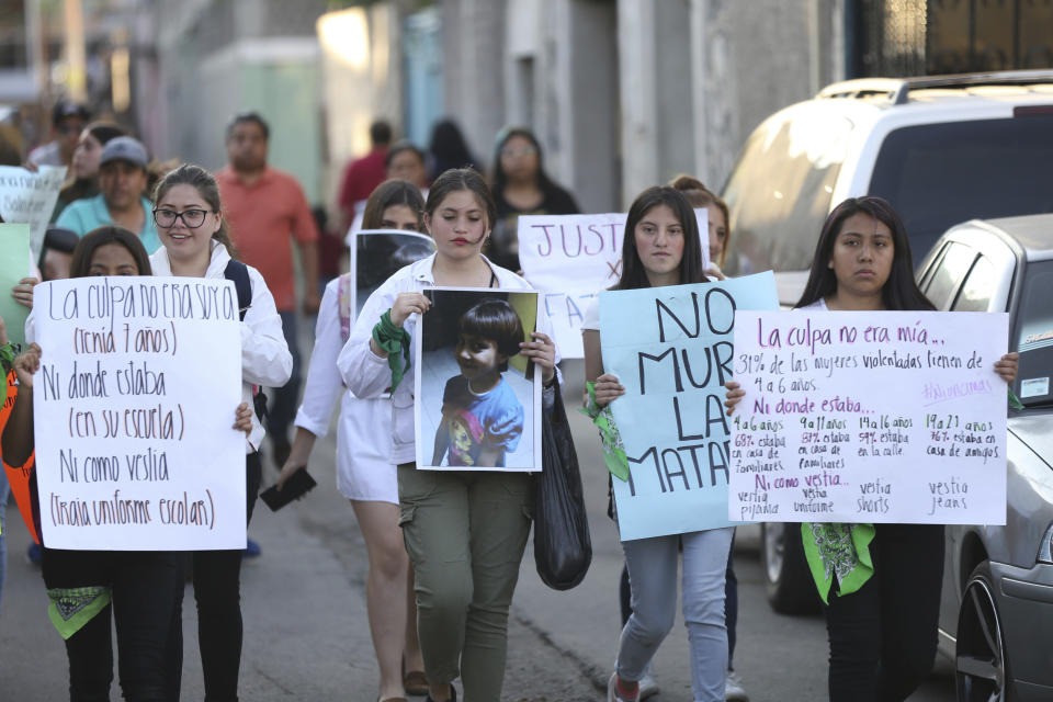 Demonstrators march to protest the murder of Fatima, a 7-year-old girl who was abducted from the entrance of the Enrique C. Rebsamen primary school and later killed, in Mexico City, Monday, Feb. 17, 2020. The girl's body was found wrapped in a bag and abandoned in a rural area on Saturday and was identified by genetic testing. (AP Photo/Marco Ugarte)