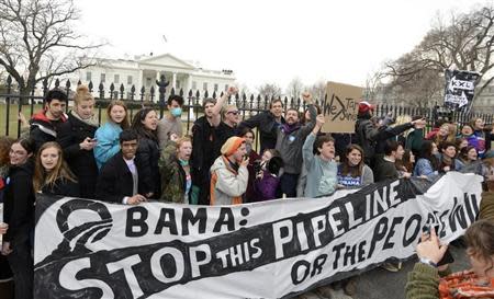 Environmentalists, many of whom have zip-tied themselves to the fence of the White House in Washington, rally and call on U.S. President Barack Obama to reject the Keystone XL pipeline in this March 2, 2014 file photo. Billionaire Tom Steyer's take-no-prisoners stance on Keystone has raised questions about whether he might undercut the party's chance to retain control of the Senate. REUTERS/Mike Theiler/Files