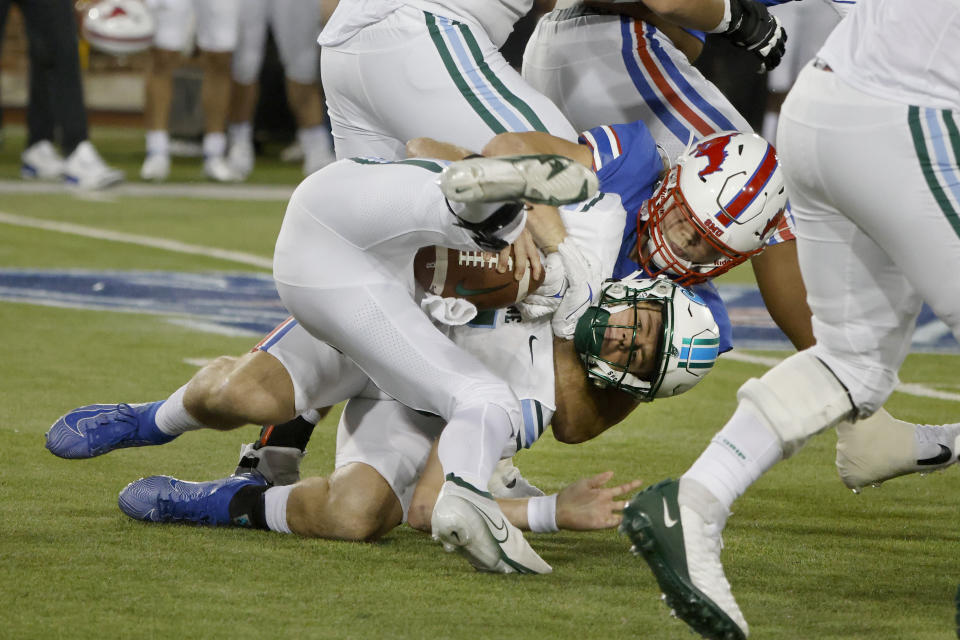 SMU defensive end Turner Coxe, right, sacks Tulane quarterback Michael Pratt during the first half of an NCAA college football game in Dallas, Thursday, Oct. 21, 2021. (AP Photo/Michael Ainsworth)