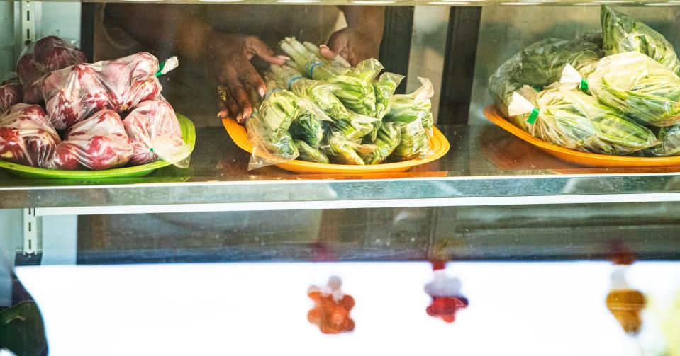 Vegetables are placed into a cooler at the Tropicaya Fresh Produce on Pine Island Road.