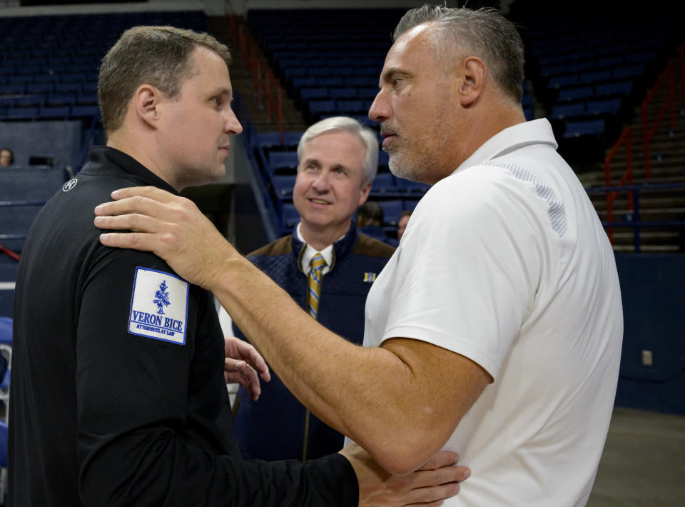 McNeese State coach Will Wade, left, talks with athletic director Heath Schroyer, right, who served as coach for three seasons, and Wade Rousse, vice president for university advancement at McNeese, after the team's win over New Orleans in an NCAA college basketball game Wednesday, March 6, 2024, in New Orleans. Wade was suspended for the first 10 games of the 2023–24 season by the NCAA but the team went to a 28-3 record and finished first in the Southland Conference. (AP Photo/Matthew Hinton)