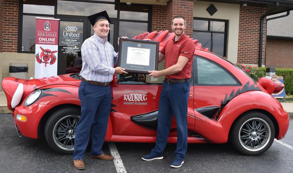 Newton “Trey” Jenkins III receives his Bachelor of Science in Accounting from Matt Willingham, assistant director of online programs for the U of A Sam M. Walton College of Business.