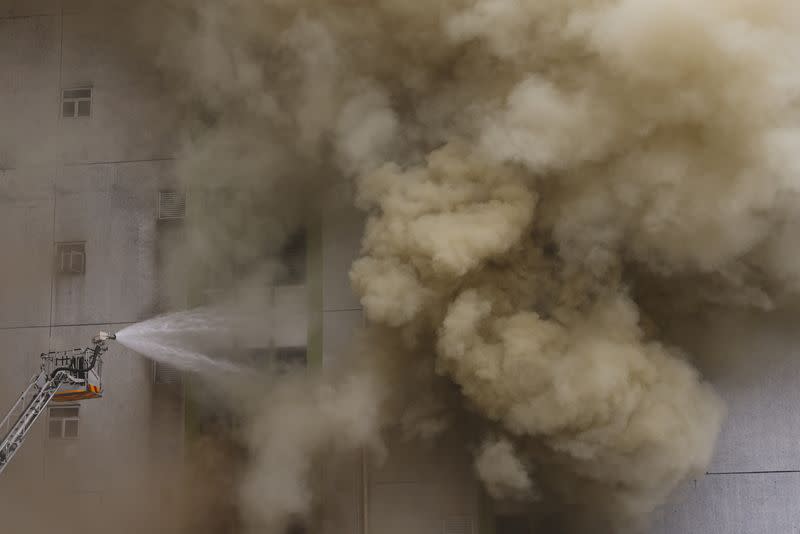 A blaze is seen at a warehouse in the city's bustling Kowloon district, in Hong Kong