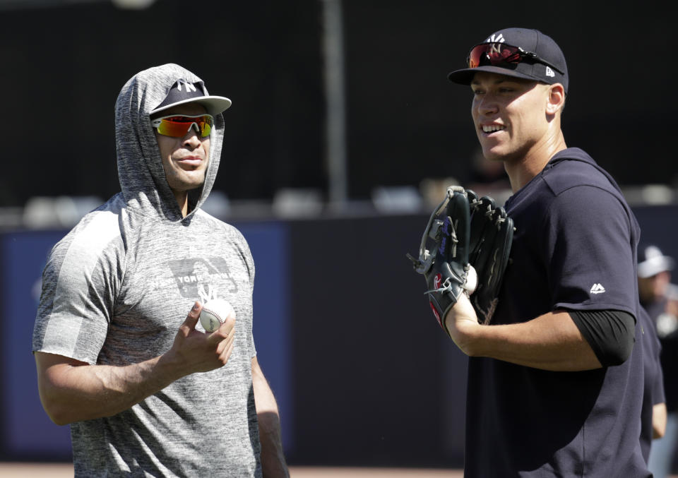 New York Yankees' Giancarlo Stanton, left, and Aaron Judge do drills at the Yankees spring training baseball facility, Thursday, Feb. 21, 2019, in Tampa, Fla. (AP Photo/Lynne Sladky)