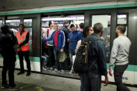 Commuters board a train, in Gare du Nord railway station, in Paris, Friday, Sept. 13, 2019. Paris metro warns over major strike, transport chaos Friday. (AP Photo/Thibault Camus)