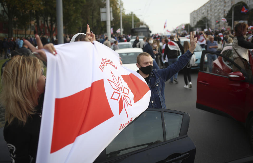 People march during an opposition rally to protest the official presidential election results in Minsk, Belarus, Sunday, Oct. 4, 2020. Hundreds of thousands of Belarusians have been protesting since the Aug. 9 presidential election. (AP Photo)