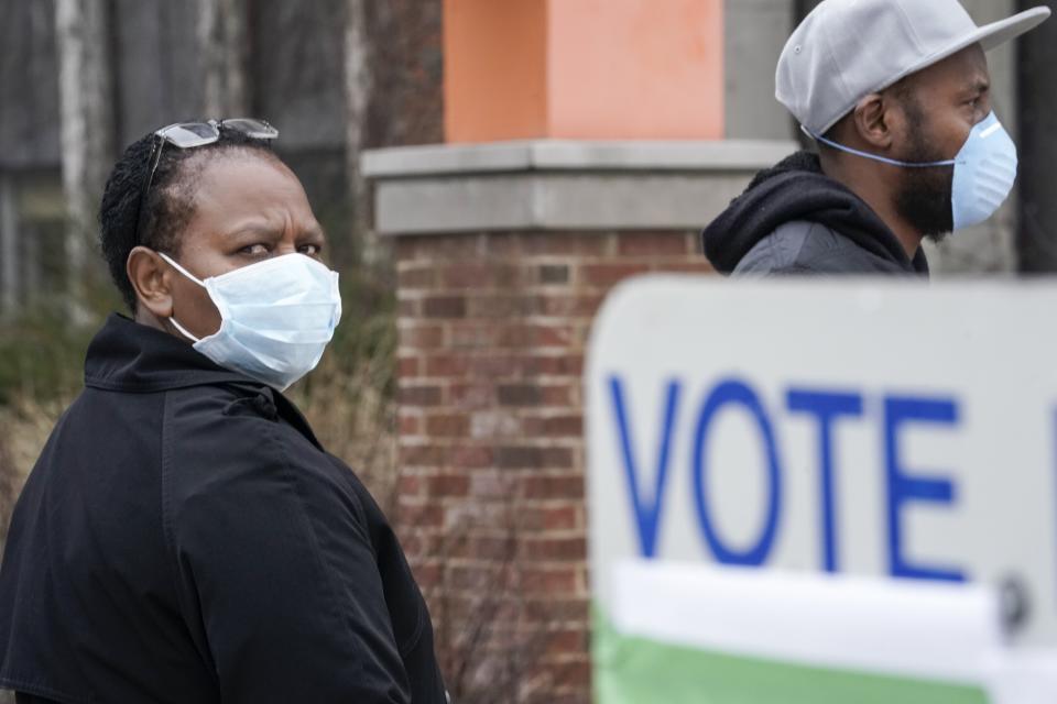 Voters masked against the coronavirus line up to vote at Riverside High School in Milwaukee. (Photo: AP Photo/Morry Gash)