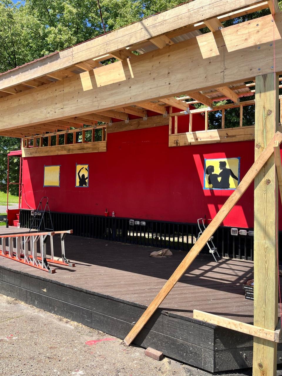 The Downtown Alliance Caboose stage has been repainted, giving it a musically themed design. Students from Alliance High School art classes took part in the work, which includes paintings on the now-closed windows featuring people dancing inside.