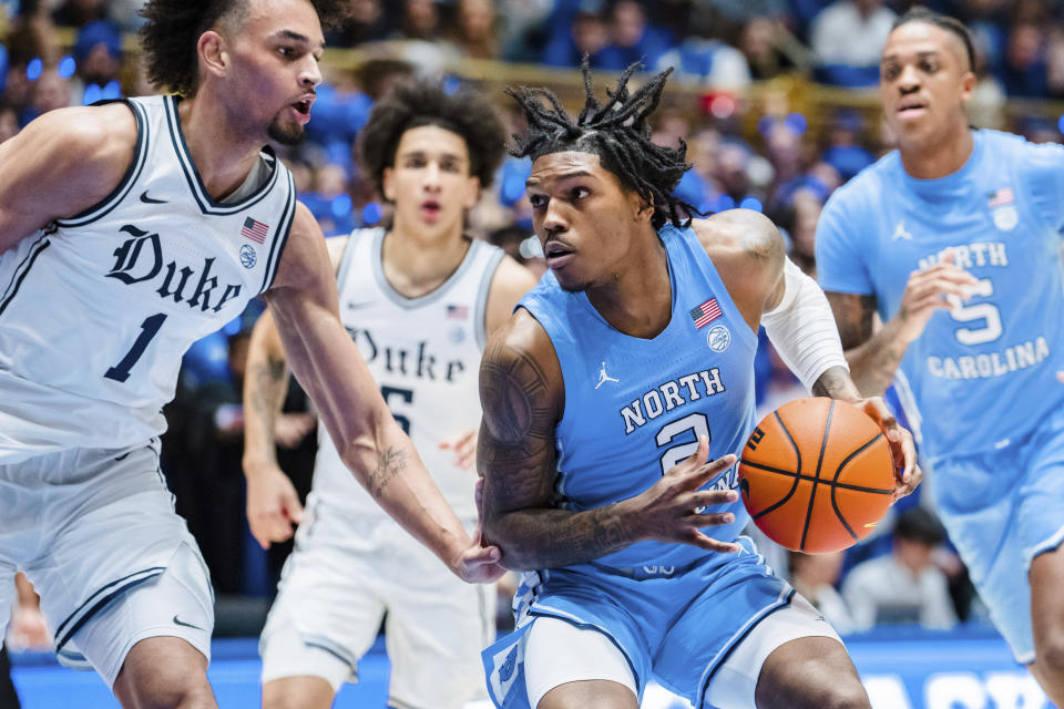 Duke center Dereck Lively II (1) guards against North Carolina guard Caleb Love (2) in the first half of an NCAA college basketball game on Saturday, Feb. 4, 2023, in Durham, N.C. (AP Photo/Jacob Kupferman)