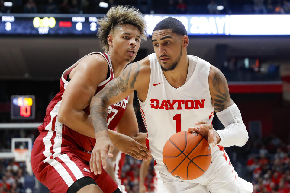 Dayton's Obi Toppin (1) drives against Massachusetts' Tre Mitchell, left, during the first half of an NCAA college basketball game, Saturday, Jan. 11, 2020, in Dayton. (AP Photo/John Minchillo)