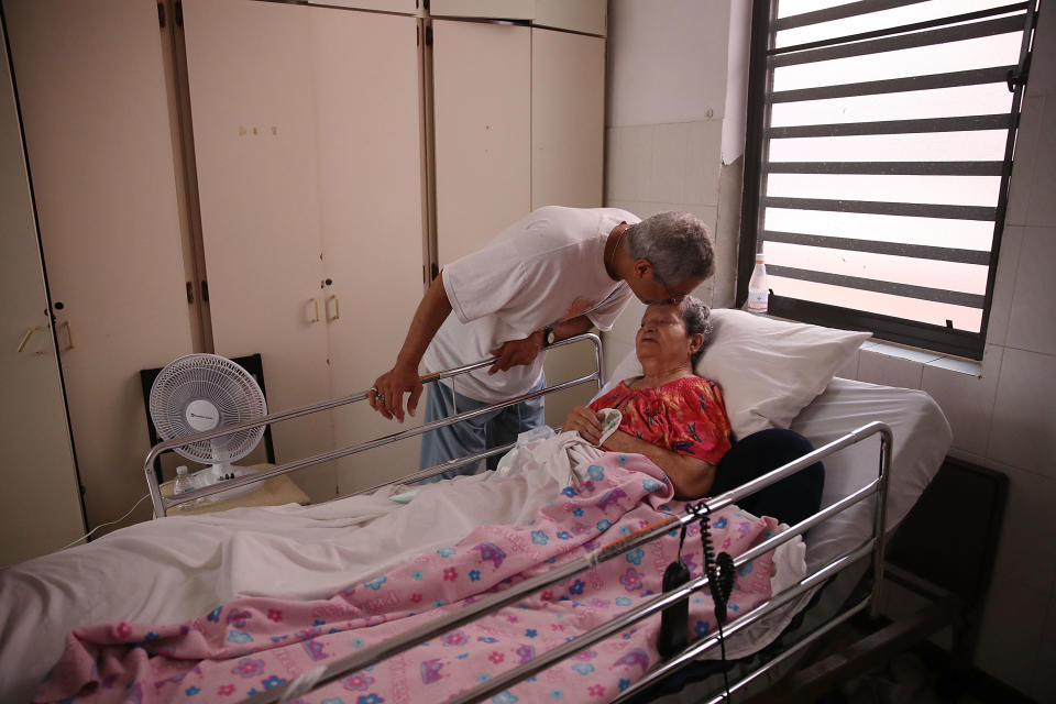 <p>Rafael Robles-Ortiz kisses his mother Josefina Ortiz who is staying at the Hermanitas de los Ancianos Desamparados facility which cares for the elderly as they deal with the aftermath of Hurricane Maria on Sept. 26, 2017 in San Juan, Puerto Rico. Mr. Robles-Ortiz is concerned for his mother and hopes aid — including fuel for the facilities generators, as well as food and medicine for his mother — gets through after Hurricane Maria, a category 4 hurricane, devastated the island. (Photo: Joe Raedle/Getty Images) </p>