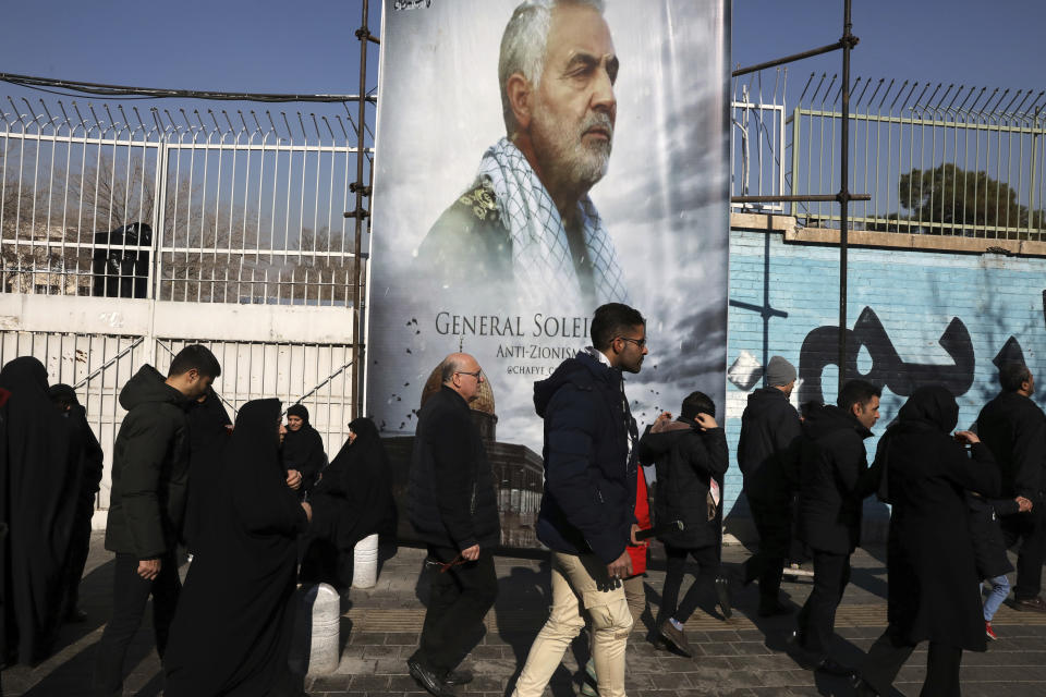 Mourners walk back from a funeral ceremony for Iranian Gen. Qassem Soleimani in front of the former U.S. Embassy, who was killed with others in Iraq by a Friday U.S. drone attack, Monday, Jan. 6, 2020. Funeral ceremonies for Soleimani drew a crowd said by police to be in the millions, on Monday in Tehran, where his replacement vowed to take revenge. (AP Photo/Vahid Salemi)