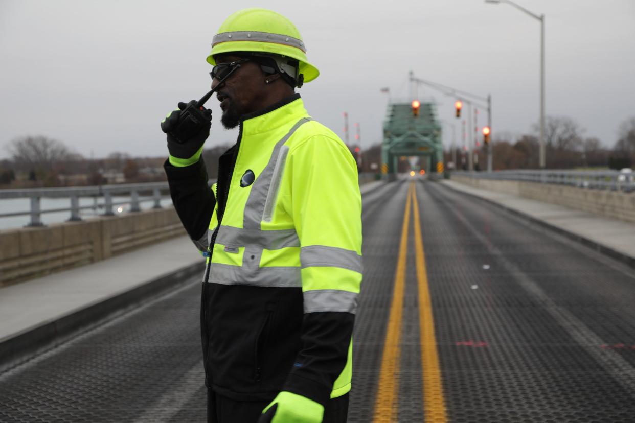 Kevin Gunn, 60, of the Wayne County Dept. of Public Services officially radios to open the Grosse Ile Parkway Free bridge.