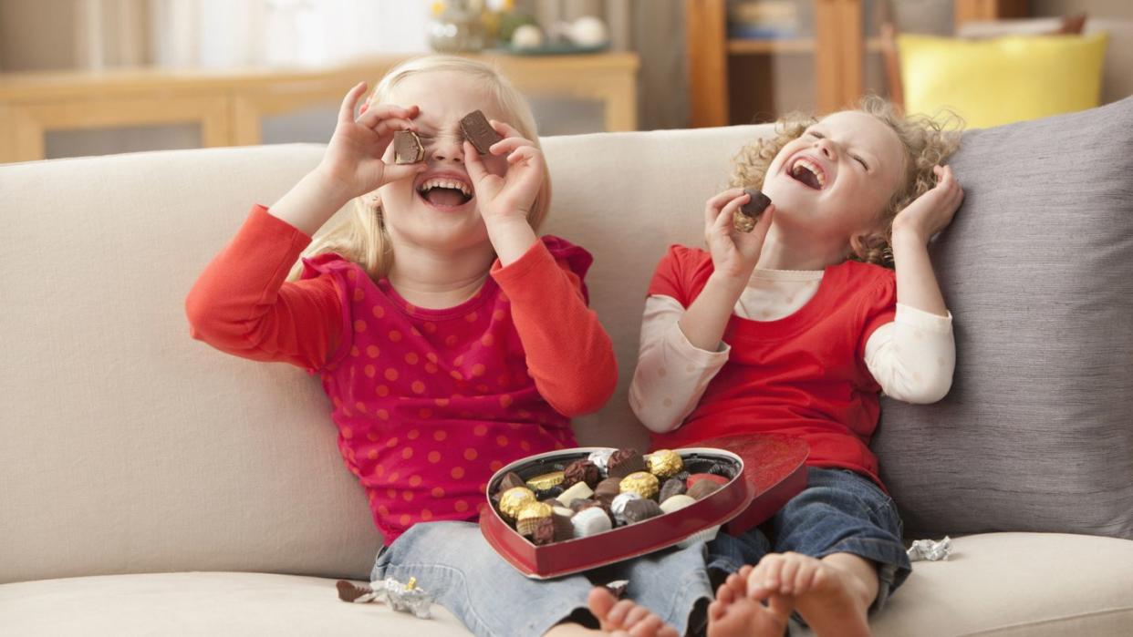 caucasian girls eating valentine's candy