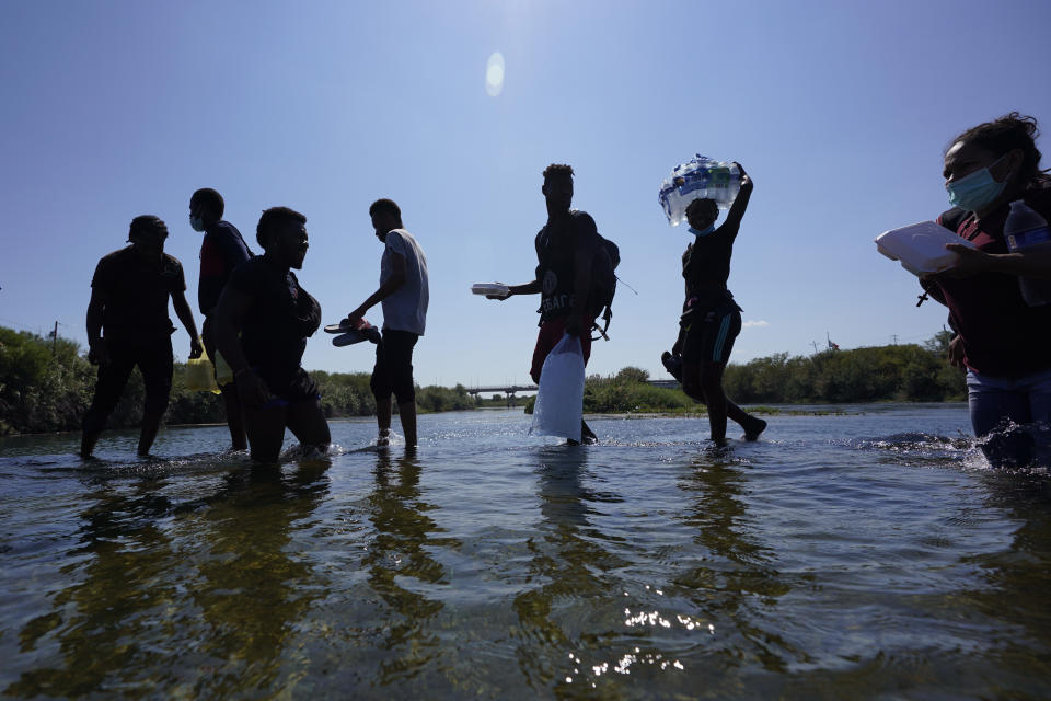 Haitian migrants use a dam to cross to and from the United States from Mexico, Friday, Sept. 17, 2021, in Del Rio, Texas. Thousands of Haitian migrants have assembled under and around a bridge in Del Rio presenting the Biden administration with a fresh and immediate challenge as it tries to manage large numbers of asylum-seekers who have been reaching U.S. soil. (AP Photo/Eric Gay)