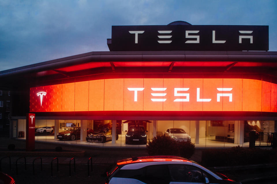 London:  View from the street of Tesla Motors showroom with multiple luxury Tesla cars inside. Tesla is an American company that designs, manufactures, and sells electric cars