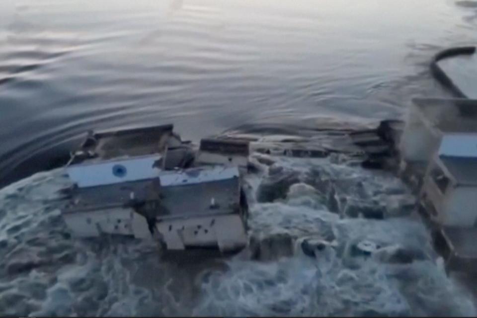 floodwaters rush over buildings