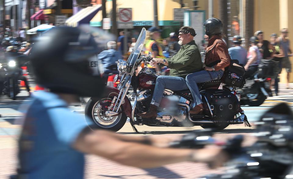 Riders on Atlantic Avenue cruise past Main Street on Saturday during Biketoberfest in Daytona Beach. This year's 30th anniversary edition of the four-day event offered a welcome boost to area businesses in the wake of damages and disruptions from Tropical Storm Ian.