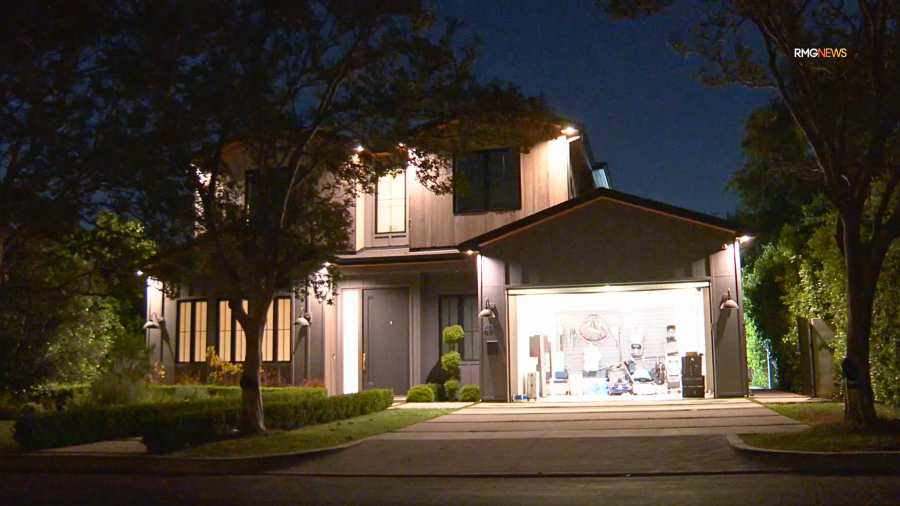 Los Angeles police investigate a reported burglary in Encino