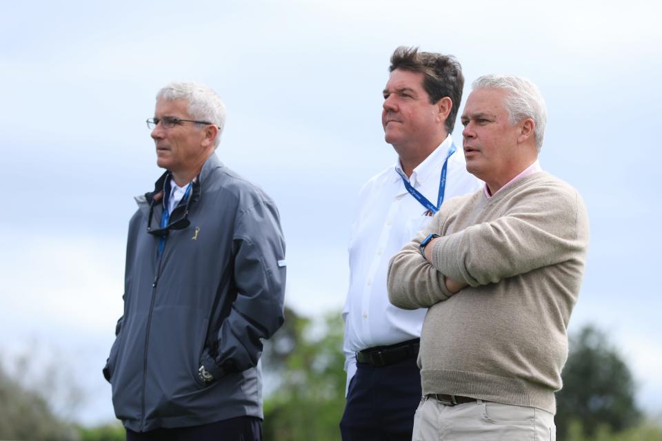 Ty Votaw (right) watches action during the final round of the 2022 Players Championship with PGA Tour commissioner Jay Monahan (left) and past Players chairman Tim Tresca.