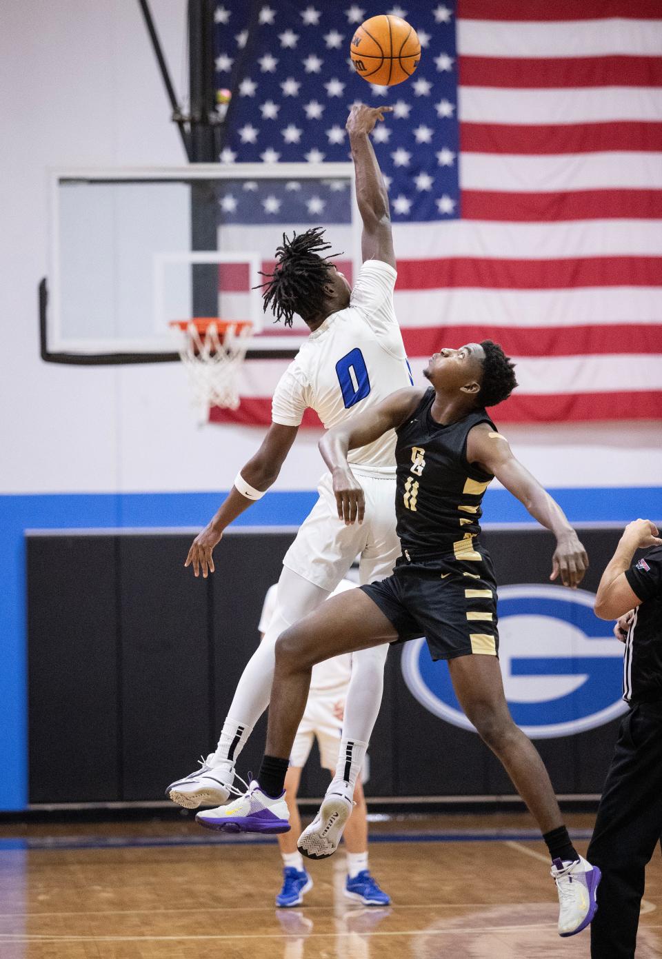 Patrick Johnson of Gateway Charter jumps up for the opening tipoff with Whylkeems Estimond of Golden Gate on Tuesday, Jan. 30, 2024, at Gateway Charter High School in Fort Myers.