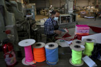An employee packs notebooks at Oriental Paper Products, a stationery factory that for years exported stationary to Saudi Arabia, in the Beirut suburb of Roumieh, Lebanon, Nov. 5, 2021. Job opportunities lost and contracts canceled are just some of the ways that ordinary Lebanese have been affected by Saudi Arabia’s furious backlash at Lebanon late last month over comments made by a Cabinet minister deemed critical of its war in Yemen. (AP Photo/Bilal Hussein)